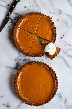 two pies sitting on top of a marble counter