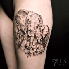 an elephant and flowers tattoo on the thigh