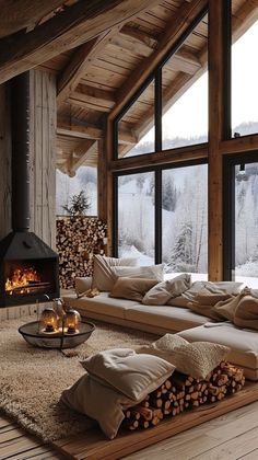 a living room filled with furniture and a fire place in front of a window covered in snow