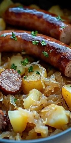 two sausages and potatoes in a bowl with parsley on the side, ready to be eaten