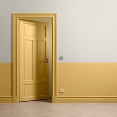 an empty room with a yellow door in it