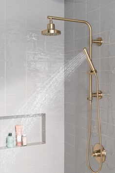 an open shower head with the spray coming from it's spout, in a white tiled bathroom