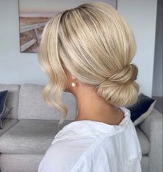 a woman with blonde hair in a low bun