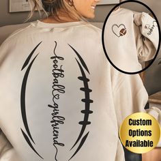 Custom Football Girlfriend Sweatshirt Introducing our charming Football-themed sweatshirt, perfect for proud Football Girlfriends everywhere! Featuring a unique design with football laces on the back and the phrase "Football Mama" placed down the spine, this sweatshirt is a true standout. Personalize it with your favorite player's name displayed on the sleeve for an extra special touch. Key Features: Cozy Fabric: Crafted from a warm blend of 50% cotton and 50% polyester, this unisex heavy blend Diy Football Shirts For Girlfriends, Boyfriend Football Shirts Girlfriends, Football Shirt Designs For Girlfriends, Football Sweatshirt Designs Girlfriend, Sunday Night Football Shirts For Girlfriemd, Homecoming Football, Sport Ideas, Sports Mom Gifts