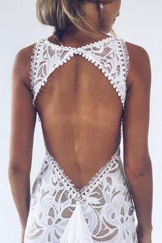 the back of a woman's white swimsuit with an openwork design on it