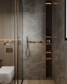 a bathroom with a toilet, shower head and shelves on the wall next to it