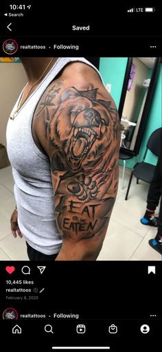 a man's arm with a tiger tattoo on it and the words eat them