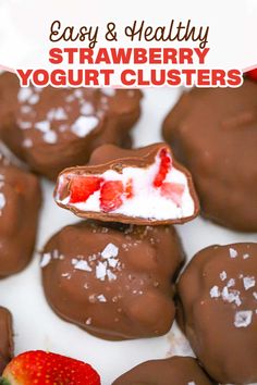 chocolate covered strawberry yogurt clusters on a white plate with strawberries in the background