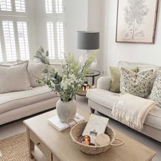 a living room filled with furniture and a lamp on top of a table in front of a window