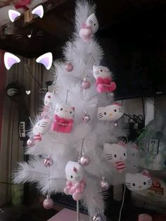 a white christmas tree decorated with hello kitty ornaments