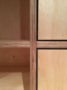 a close up of the bottom part of a cabinet with wood grained panels and drawers