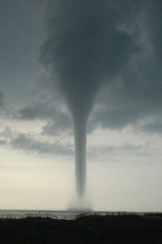 a large tornado is coming out of the sky