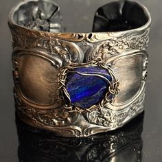 Thanks For Looking At This Handmade One Of A Kind Cuff Bracelet Made With Antique Victorian Sterling Silver Gorham (Circa Early 1900's) This Is Gorham Buttercup, There Are Some Holes (Filagree?) , In The Sterling, But Nothing That Will Deter From The Structure So I Wire Wrapped Genuine Lapis To It With Solid Sterling Silver I Preserved This Stunning Antique. Saved From " Destruction Fits Large Wrists,6.5" -7.5" , Slightly Adjustable Tested Sterling Silver All Edges Are Smooth 2 Inches Wide 55.7 Adjustable Blue Cuff Bracelet For Anniversary, Adjustable Blue Engraved Cuff Bracelet, Elegant Blue Cuff Bracelet With Polished Finish, Artisan Blue Engraved Cuff Bracelet, Handmade Fusion Style Sterling Silver Cuff Bracelet, Unique Antique Silver Sterling Silver Bracelet Gift, Handmade Sterling Silver Fusion Cuff Bracelet, Unique Antique Silver Sterling Silver Bracelet For Gift, Unique Antique Silver Sterling Bracelet As Gift