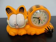 a yellow tiger clock sitting on top of a table