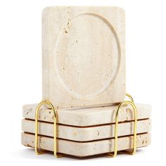 a set of four marble coasters with gold handles on each one and a plate in the middle