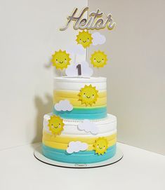 a three tiered cake with sun decorations on top and the word hello written above it