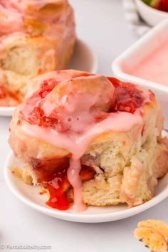 strawberry bundts with icing and strawberries on the side, ready to be eaten