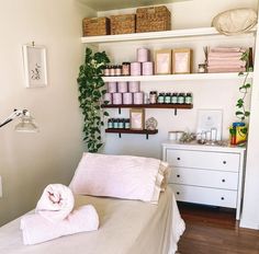 a bedroom with shelves and towels on the bed