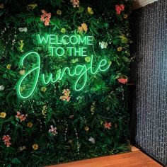 a green wall with the words welcome to the jungle