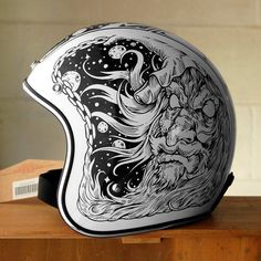 a motorcycle helmet sitting on top of a wooden table