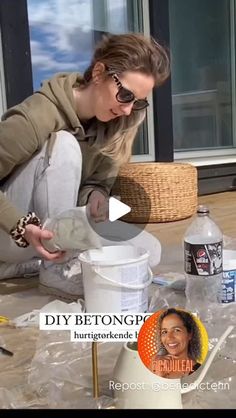 a woman is making something out of plastic