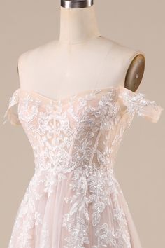 a dress on a mannequin with white flowers and lace overlaying it