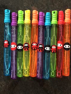 six different colored pens with cartoon characters on them