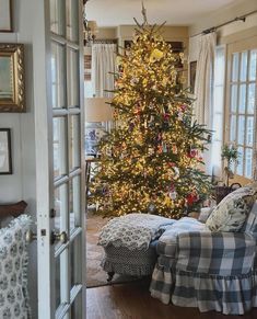 a living room with a christmas tree in the corner