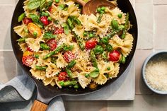 a skillet filled with pasta and vegetables