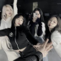 the girls are posing together in black and white outfits with their hands out to each other