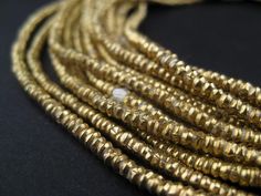 PRICES MAY VARY. Handmade by independent artisans in Ethiopia Each bead measures 1 x 2.5-3mm diameter, with hole size of 2mm Sold by the strand - wholesale value 100% Authentic Ethiopian product Official product of The Bead Chest Take a look at this great strand of Brass beads fashioned in a heishi shape. Each strand is 28" long with approximately 400 beads measuring 1 x 2.5-3mm diameter. These great beads are highly versatile and may be used as spacers or accents in your unique designs. A great Gold Multi-strand Gemstone Beads, Beads Types, Master Board, Brass Beads, Heishi Beads, Trade Beads, Brass Color, Jewelry Making Beads, Ethiopia