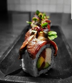 a sushi dish with avocado and other vegetables