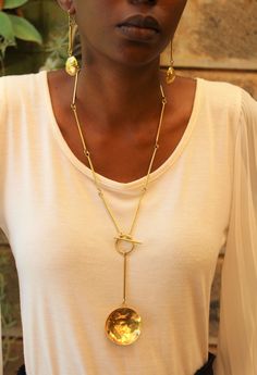 Handmade in Nairobi , Kenya! Crafted with brass pendants. Clasp is located in the front. Necklace length- 40.5cm Earrings length- 7cm SHIPPING Shipping is done via DHL Express, 3-7 days delivery, Add multiple items to your cart and pay shipping for one item ONLY! Gold Medallion Jewelry With Toggle Clasp, Metal Long Necklace With Adjustable Chain As Gift, Long Necklace Chain Jewelry As Gift, Long Necklace Chain Jewelry For Gift, Metal Long Dangle Necklace As A Gift, Metal Dangle Long Necklace For Gift, Gold Toggle Necklace With Round Metal Pendant, Dangle Long Metal Necklace As Gift, Gold Toggle Necklace With Round Pendant