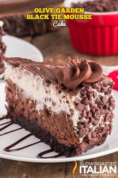 a piece of cake with chocolate and white frosting on it sitting on a plate