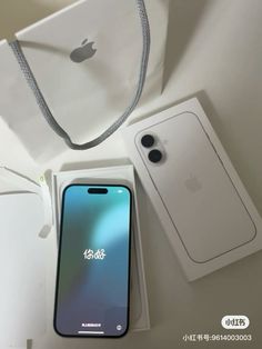 an iphone is sitting in its box next to some other items that are on the table