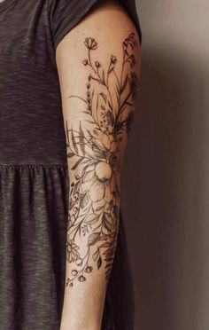 a woman with a flower tattoo on her arm