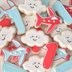 decorated cookies in the shape of airplanes and clouds