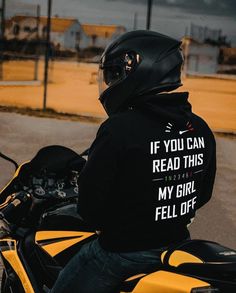 a man riding on the back of a motorcycle wearing a hoodie that says if you can read this, my girl fell off