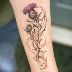 a woman's leg with a tattoo on it and flowers in the middle,