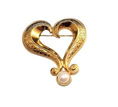 Avon extra large heart pin brooch vintage gold tone scroll engraved metal finish swirl wide fancy band round domed white end pearl bead. Signed Avon on the back of the pin brooch. In excellent vintage condition. Measures 3 1/8 inches long 2 5/8 inches wide. Elegant Gold Brooch For Valentine's Day, Elegant Gold Brooches For Valentine's Day, Scroll Engraving, Monet Earrings, Engraved Metal, Pearl Heart, Costume Earrings, Heart Pin, Large Heart