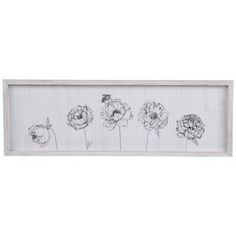 a white framed wall hanging with black and white flowers on the bottom half of it