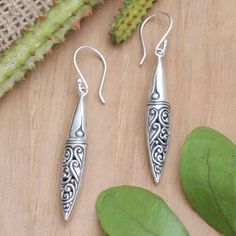 Bali's high-quality craftsmanship is present in this charming design made from sterling silver. Designed by Dewa Arimbawa, these dangle earrings feature traditional motifs in a combination finish, making an ideal accessory for casual or formal occasions. Traditional Sterling Silver Engraved Earrings, Traditional Engraved Sterling Silver Earrings, Traditional Long Drop Earrings For Pierced Ears, Traditional Engraved Teardrop Earrings, Feather Wings, Traditional Motifs, Gift Suggestions, Silver Feather, Silver Dangle Earrings