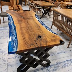 a wooden table sitting on top of a tile floor next to chairs and tables covered in wood