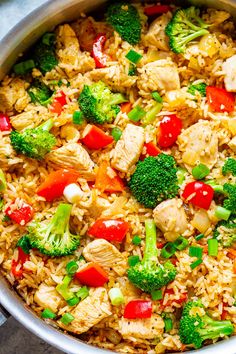 a pot filled with rice and vegetables on top of a table