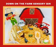 a bowl filled with corn next to a red barn and toy farm animals on top of it