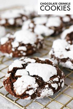 chocolate crinkle cookies with powdered sugar on top are cooling on a wire rack