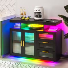 a multicolored cabinet with lights on it in the corner next to a potted plant