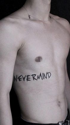 a shirtless man with the word never mind written on his chest