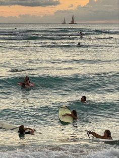 many people are in the water with surfboards