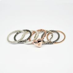 This is a set of 7 stackable rings,made of sterling silver wire 925 then soldered and 1 of them hammered.One ring has a heart with the initial of your own choice All stacking rings have a beautiful shinny finish but i can change that If you want. 2 rings are made from rose gold plated sterling silver, 2 are from black rhodium plated sterling silver and the rest 3 are from sterling silver 925. 2 ring are made from rectangle wire 1.5mm (1 silver and one rose gold plated) 2 rings is made from multi Heart Shaped Stackable Rings For Everyday, Heart-shaped Rose Gold Stackable Rings In Sterling Silver, Heart Shaped Rose Gold Sterling Silver Stackable Rings, Silver Heart Stackable Rings, Silver Heart-shaped Stackable Rings, Stackable Rings Gold, Initial Rings, Gold Stacking Rings, Stack Rings